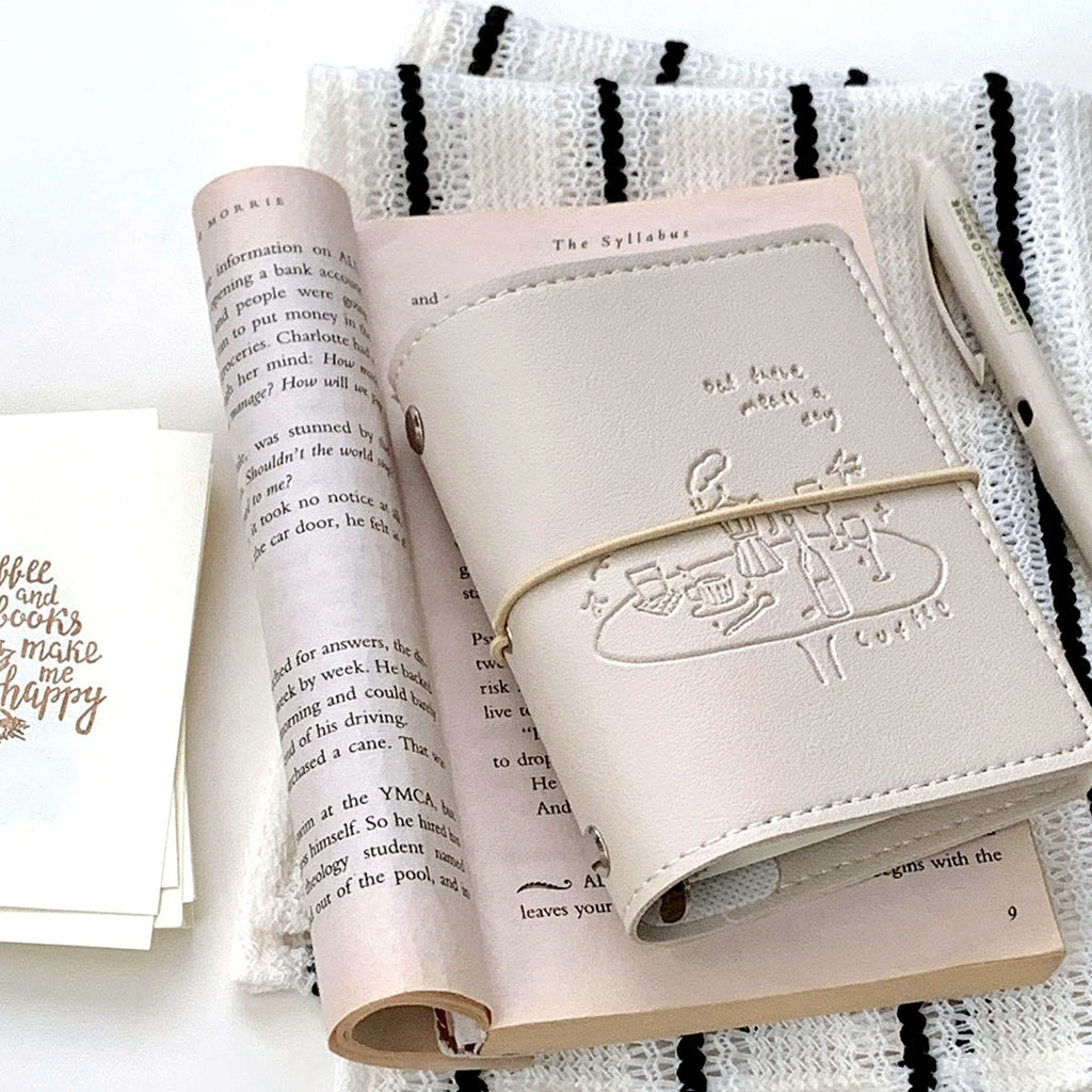 Cream Cafe M5 Refillable Binder styled with paper and desk objects.