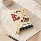 Dear Folio Ins Nepal Journal with Nepal flag and Mithila art cover styled on warm cream linen.