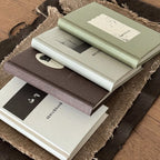 Minimal Sketch Pocket Journals stacked on a textured surface.