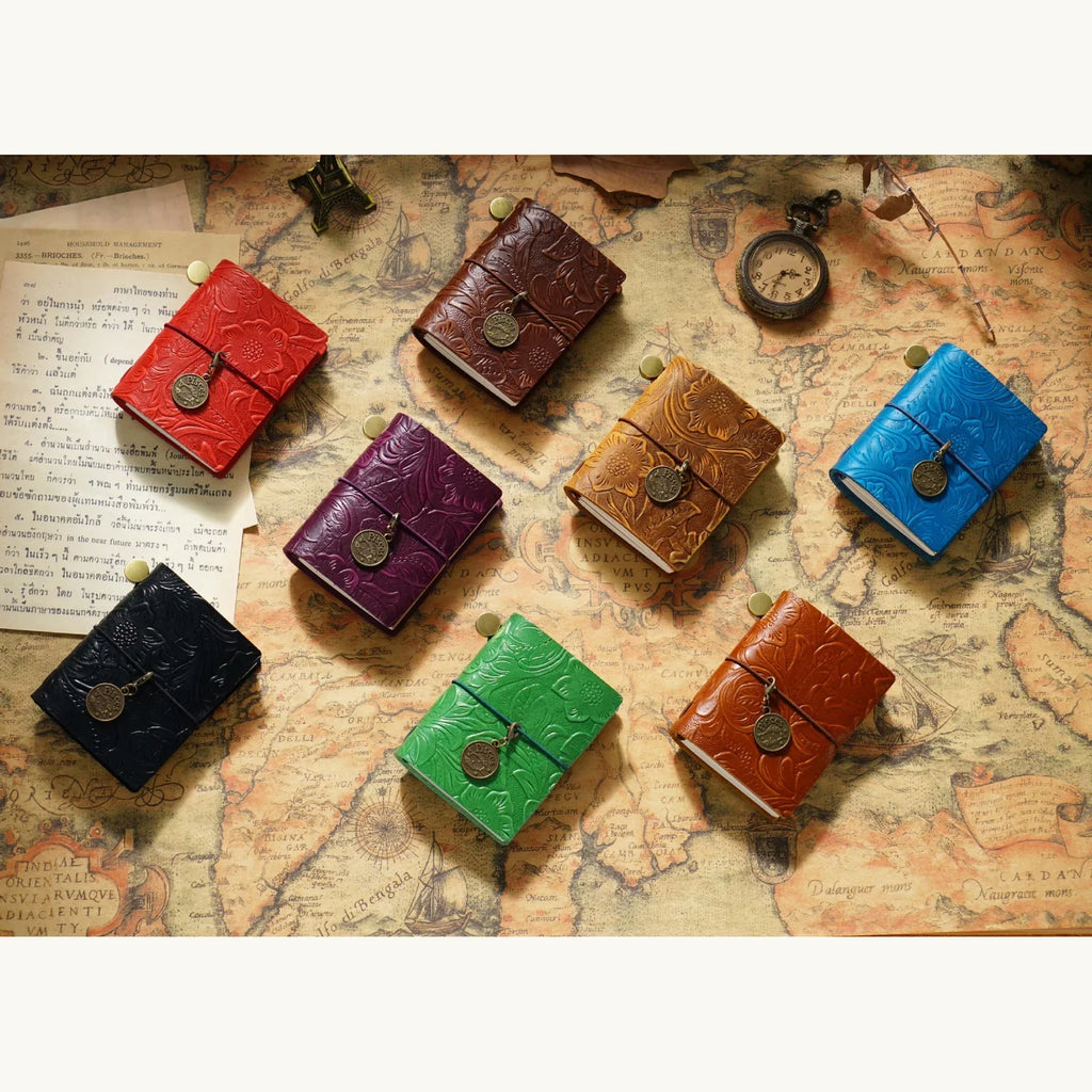 Pocket Traveler Wrap Journals arranged in assorted colors.