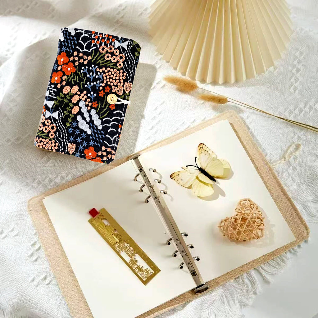 Embroidered Floral Wrap Notebook styled in a warm reading and writing setting