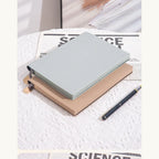 Soft Pebble A5 notebook shown with a pen for scale.