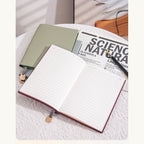 Soft Pebble A5 notebook opened to lined pages.
